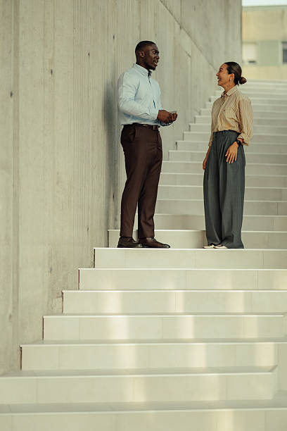 istock Business colleagues engaging in conversation on stairs 2220160517