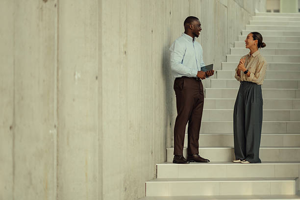 istock Business colleagues chatting on stairs during break time 2220160518