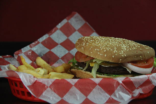 istock A classic cheeseburger served with crispy fries in a red and white checkered basket 2220160564