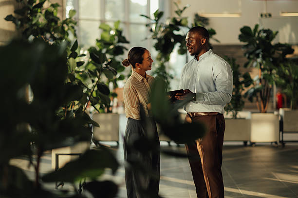 istock Business colleagues using digital tablet in modern office with plants 2220160568