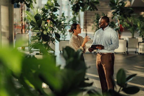 istock Businesspeople discussing work in modern green office 2220160569
