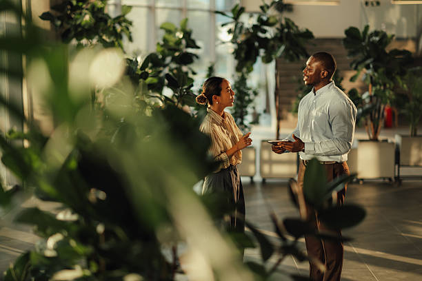 Business colleagues discussing work in modern green office