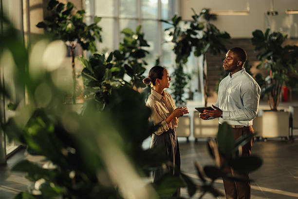 istock Business colleagues discussing work in modern green office 2220160579