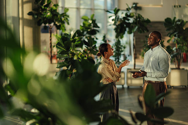 istock Businesspeople discussing work in modern green office 2220160582