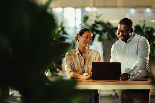 istock Business colleagues collaborating on laptop in modern office 2220160587