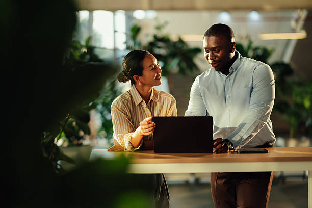 istock Business colleagues collaborating on laptop in modern office 2220160593