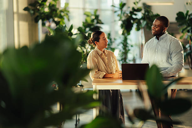 istock Business colleagues discussing work in modern green office 2220160615