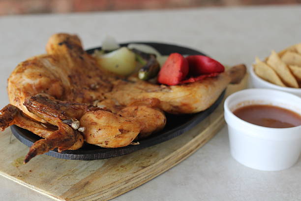 istock This image presents a beautifully chargrilled chicken platter served with colorful accompaniments 2220160617