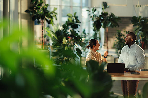 istock Business colleagues engaging in conversation in a green office space 2220160619