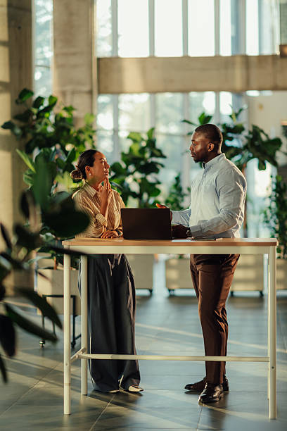 istock Business colleagues discussing a project on a laptop in a modern office 2220160621