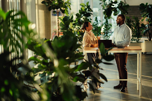 istock Business colleagues discussing work in modern green office 2220160625