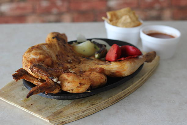 istock A beautifully presented serving of grilled chicken on a hot plate 2220160786