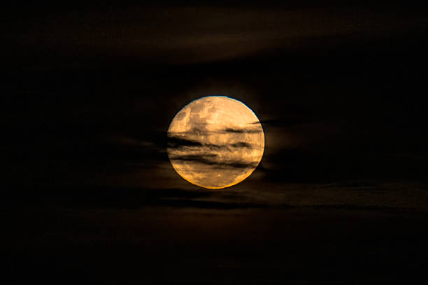 istock June's Full moon, Strawberry Moon with bands of clouds 2220165414