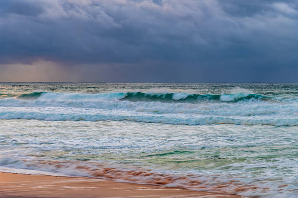 istock Moody sunrise with waves at the seaside 2220165630