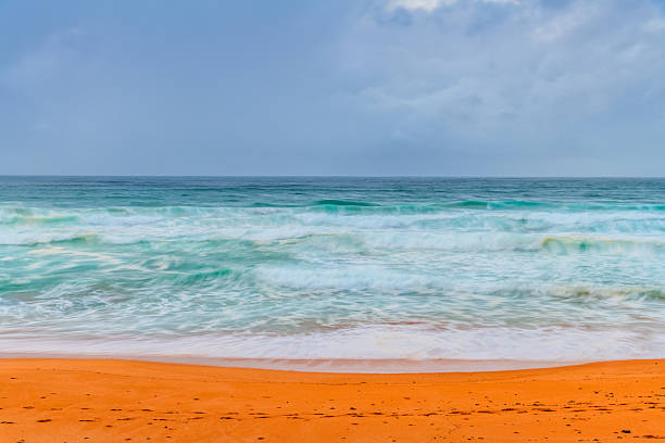 Surf's Up Sunrise with rain clouds at Avalon on the Northern Beaches of Sydney, NSW, Australia.