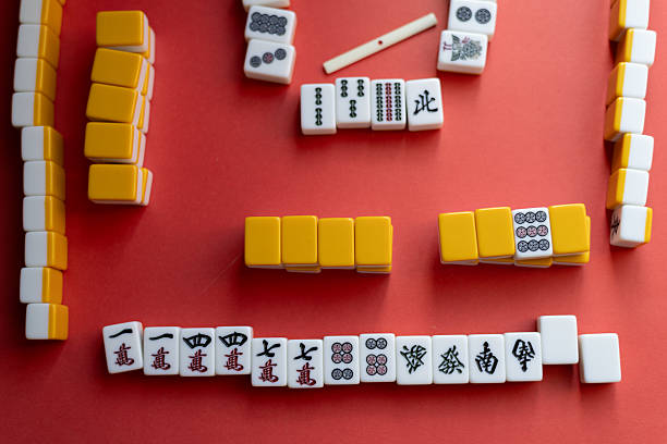 istock Mahjong tiles lined up on a red background 2220167218