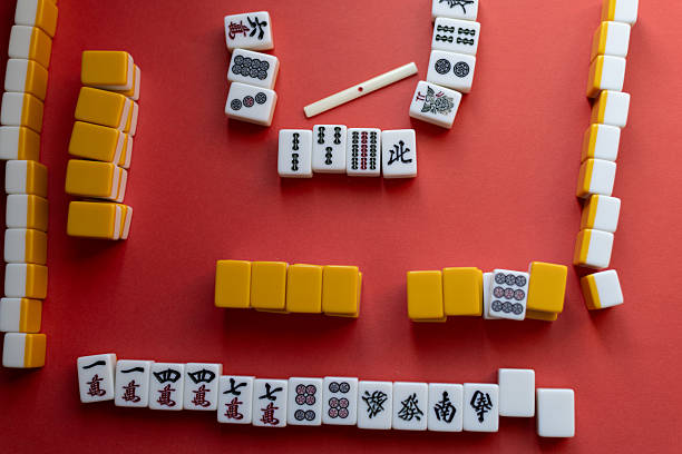 istock Mahjong tiles lined up on a red background 2220167250