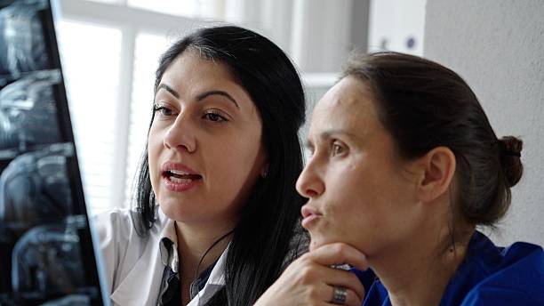 istock Female Surgeons Analyse CT Scans Before Oncology Operation 2220169470