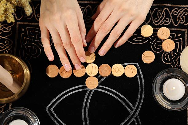 istock Woman with wooden runes at divination mat, top view 2220183301