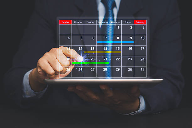 istock Businessman using tablet with holographic calendar interface, concept of planning and schedule. 2220185130