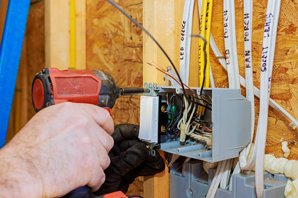 istock Electrician installs a light switch in a residential construction project in the afternoon 2220188603