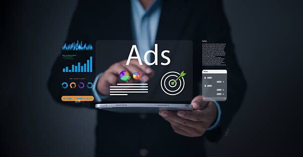 istock A businessman interacts with a digital tablet displaying targeted ads, colorful marketing graphs, performance analytics, and advertising dashboard UI for digital marketing and online campaign strategy 2220188673