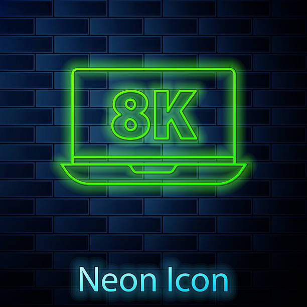 istock Glowing neon line Laptop screen with 8k video technology icon isolated on brick wall background. Vector 2220193350