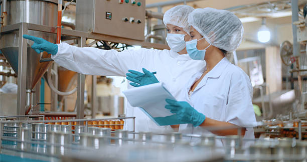istock Team reviewing production efficiency on food processing plant. 2220195060