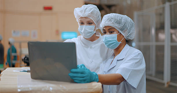 istock Team reviewing production efficiency on food processing plant. 2220195134