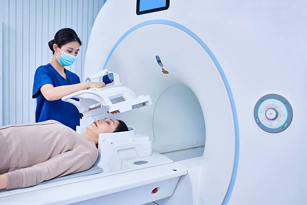 istock Female Nurse Put Protective Helmet for the Patient 2220195474