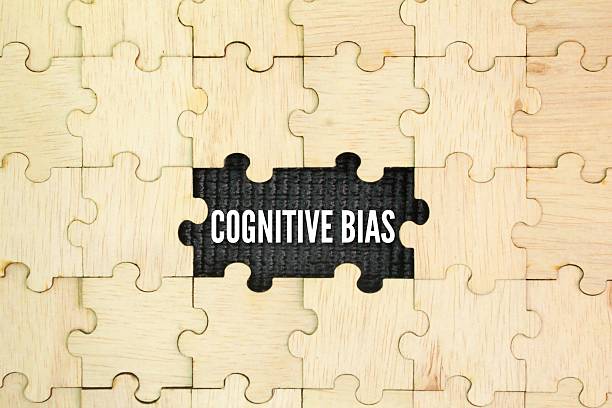 istock Wooden puzzle with the word Cognitive bias. a systematic thought process caused by the tendency of the human brain to simplify information processing through a filter of personal experience 2220204169