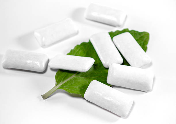 istock Refreshing chewing gums in dragees on a white background, mint leaf 2220205318