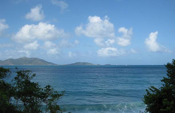 istock Tropical Seascape with Ocean Waves and Distant Green Islands under Blue Sky 2220205476