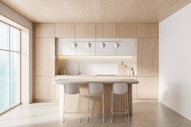 istock Minimalist light wood kitchen interior with island, pendant lights, and tall chairs in modern open space with large window and natural tones. 3D Rendering 2220206736