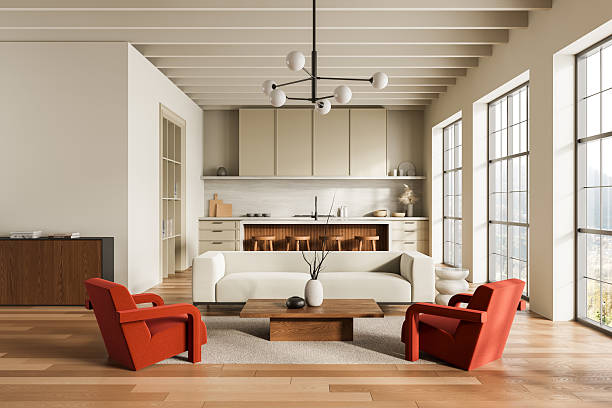 istock Modern open-plan interior with minimalist kitchen and cozy living area featuring red chairs and large windows in natural daylight. 3D Rendering 2220207278