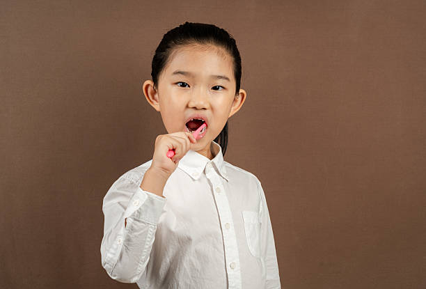 istock Little Girl Brushing Teeth 2220207891