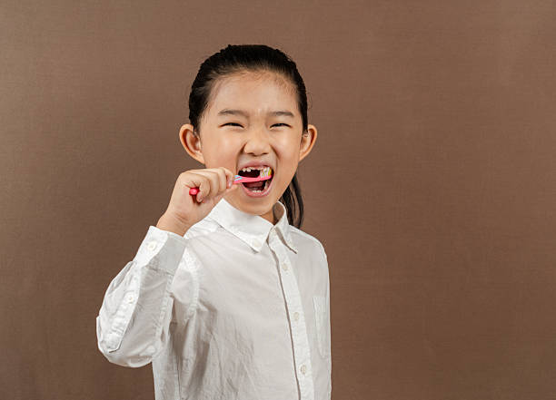 istock Little Girl Brushing Teeth 2220209524