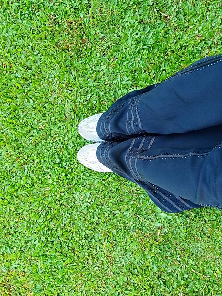 istock Human Legs on Green Grass in Outdoor Park 2220212970