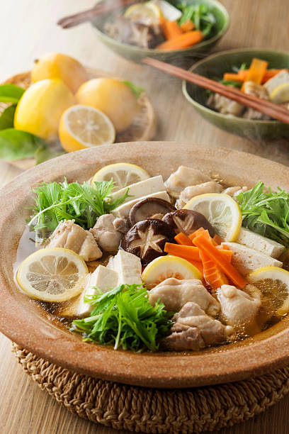 Chicken simmered in a salt‑and‑lemon broth hot pot.