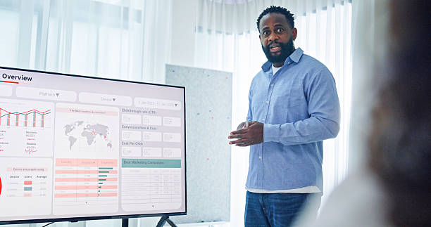 istock Group of business professionals meeting reviewing global data analytics discussing data analytics during a presentation, discussing strategy and growth standing at the office. Finance meeting concept. 2220215545