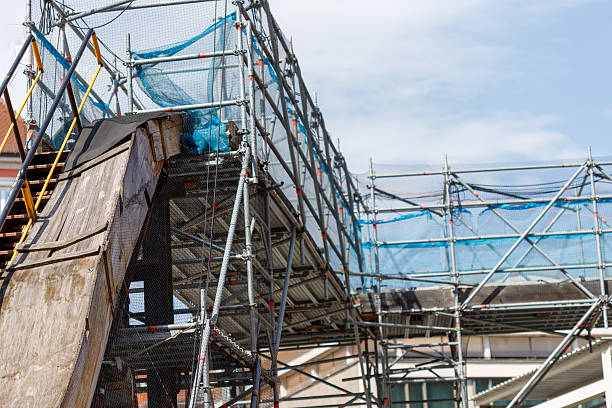 istock Exterior View of Scaffolding and Ramp Structure with Safety Netting 2220215952