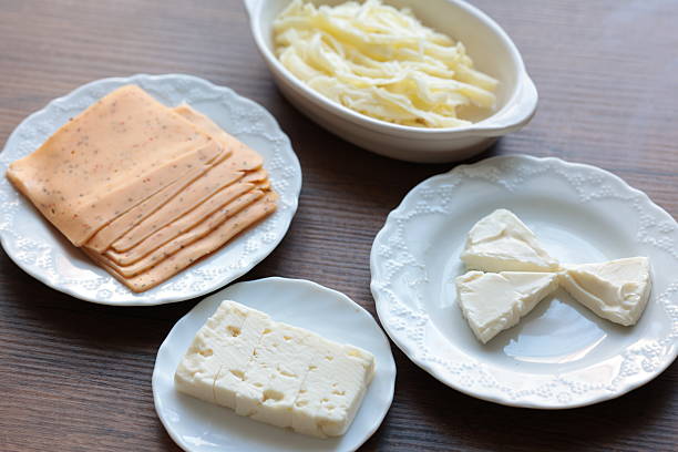 bread rusks with fresh cream cheese and vegetable decoration on a white plate and placemat