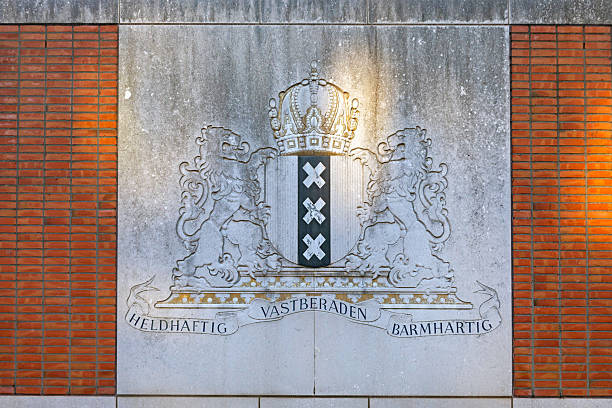 Amsterdam, Netherlands - May 14, 2018: Coat of Arms Symbol of City Three Silver Saint Andrew Crosses Official Sign at Brick Building Wall.