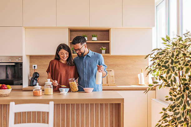 istock Young couple preparing breakfast together in modern kitchen 2220218726