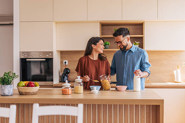 istock Happy couple preparing breakfast together in modern kitchen 2220218727
