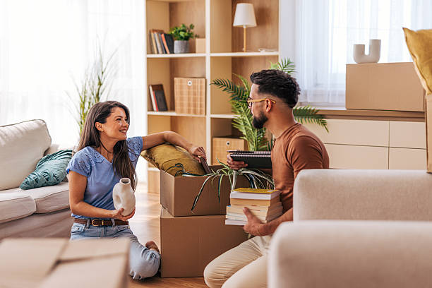 istock Young couple unpacking boxes in new home after moving in 2220218976