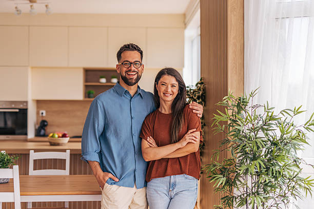 istock Happy couple smiling and posing in modern kitchen 2220219381