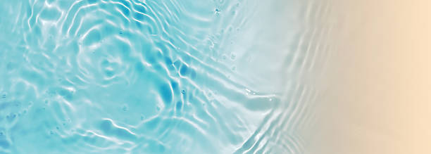 istock abstract blue water wave with sunlight reflection at sand beach from above, textured nature background banner concept with copy space for beach holiday, beauty spa, travel and vacations 2220220003