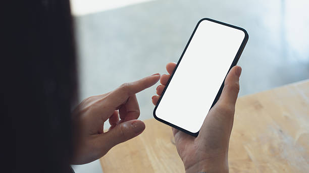 istock Mockup, blank screen cell phone. Woman hand holding, using mobile phone at cafe with white empty space for advertise text. contact business, social meida communication, technology device, closeup 2220220356