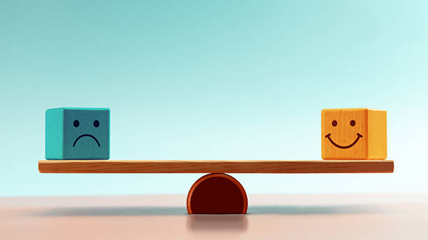 istock Balancing emotions shown with happy and sad blocks on a Balance Scale, symbolizing Mental health management and emotional control 2220221164